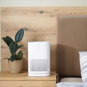 a dehumidifier in the bedroom by the bed